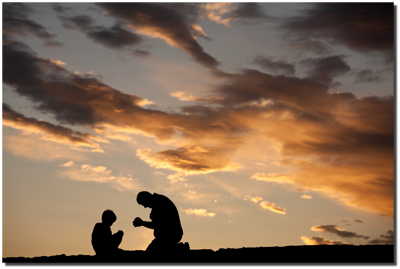 man and child kneeling in prayer